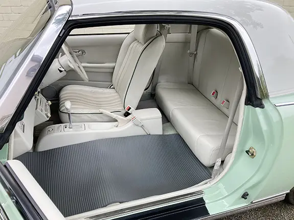 Nissan Figaro interior with front passenger seat removed for wedding dress space