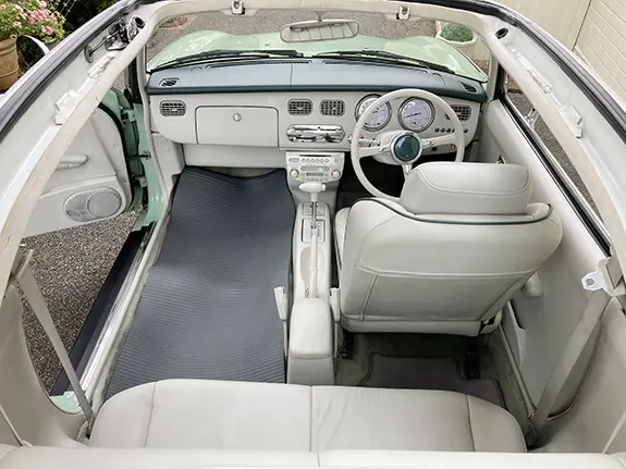 Spacious Nissan Figaro back seat for bridal dress
