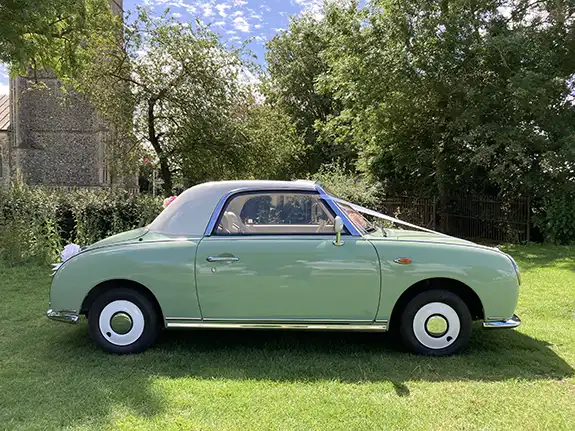 Close-up of classic Nissan Figaro wedding car front